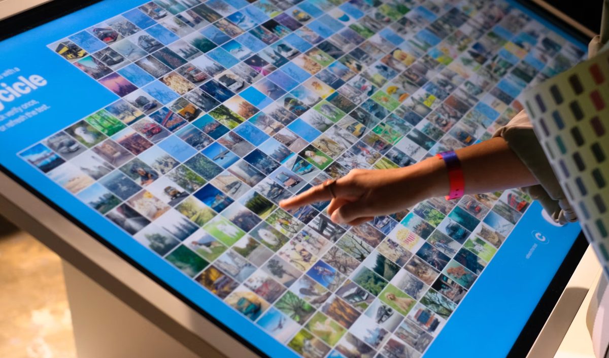 Close-up of a hand using the multi-touch table surface